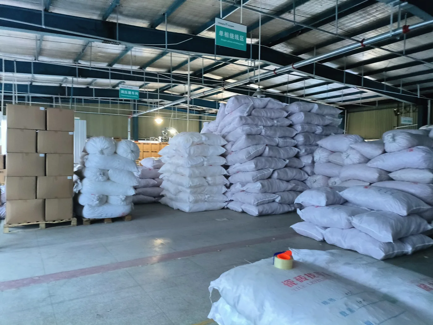 Packed bags and export cartons of tile leveling clips stored in the warehouse